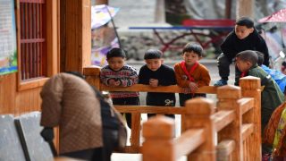 (211215) -- RONGSHUI, Dec. 15, 2021 (Xinhua) -- Students watch renovation of their classroom of the teaching point at Wuying Village, which lies on the border between south China's Guangxi Zhuang Autonomous Region and southwest China's Guizhou Province, on Dec. 9, 2021. With the support of Lianjiang City of Guangdong Province, the teaching point began to renovate classrooms, enrich libraries and build new toilets for a better studying environment. (Xinhua/Huang Xiaobang)